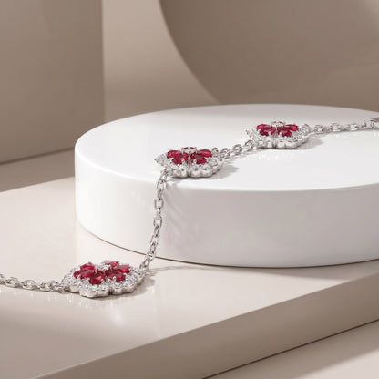 Sterling Silver Floral Bracelet – Ruby-Red Stones & Moissanite Accents