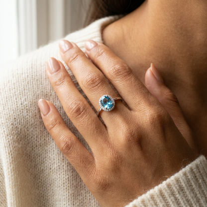 Model wearing Blue Topaz Halo ring in sterling silver