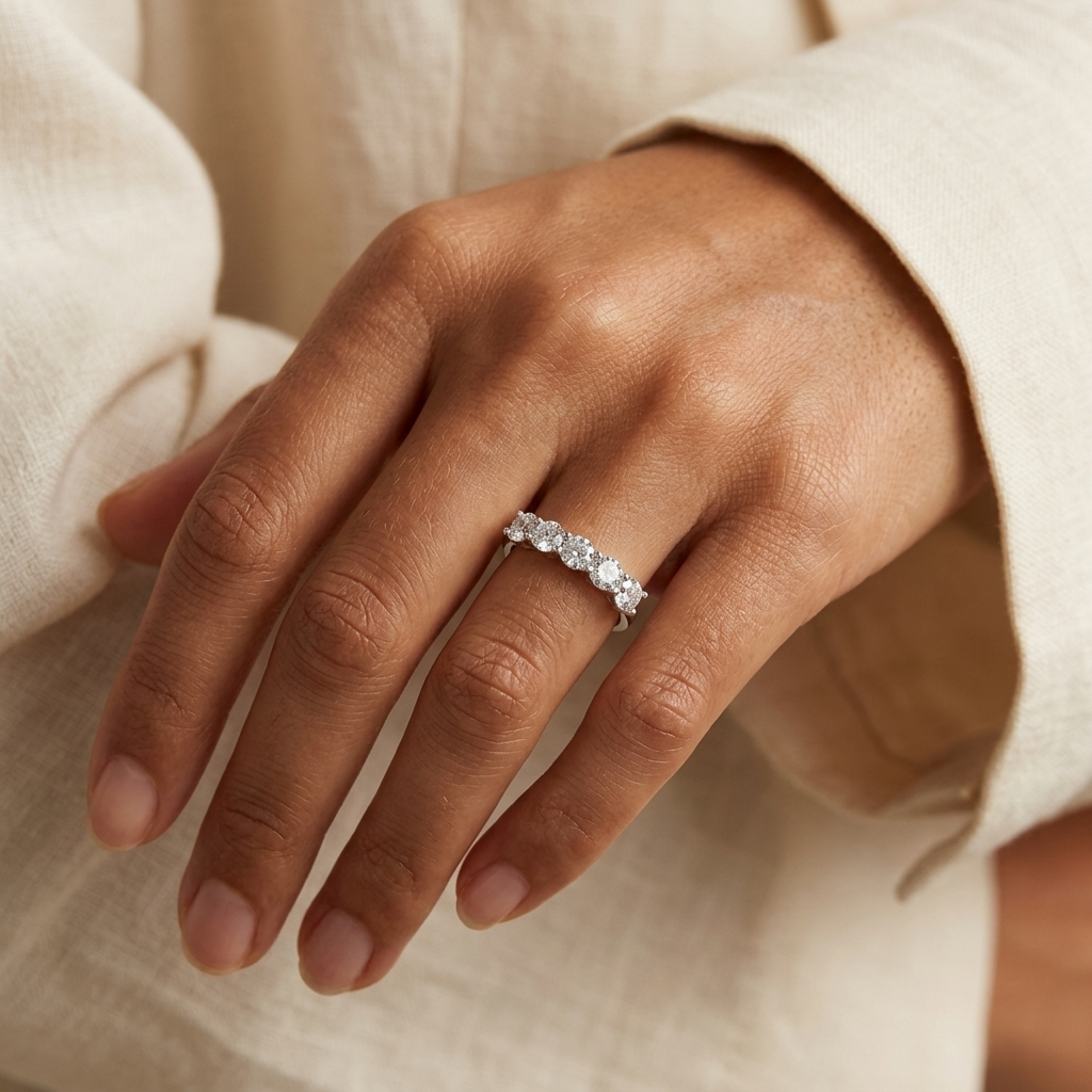 Close-up macro of Velara Milano moissanite half-eternity ring on hand